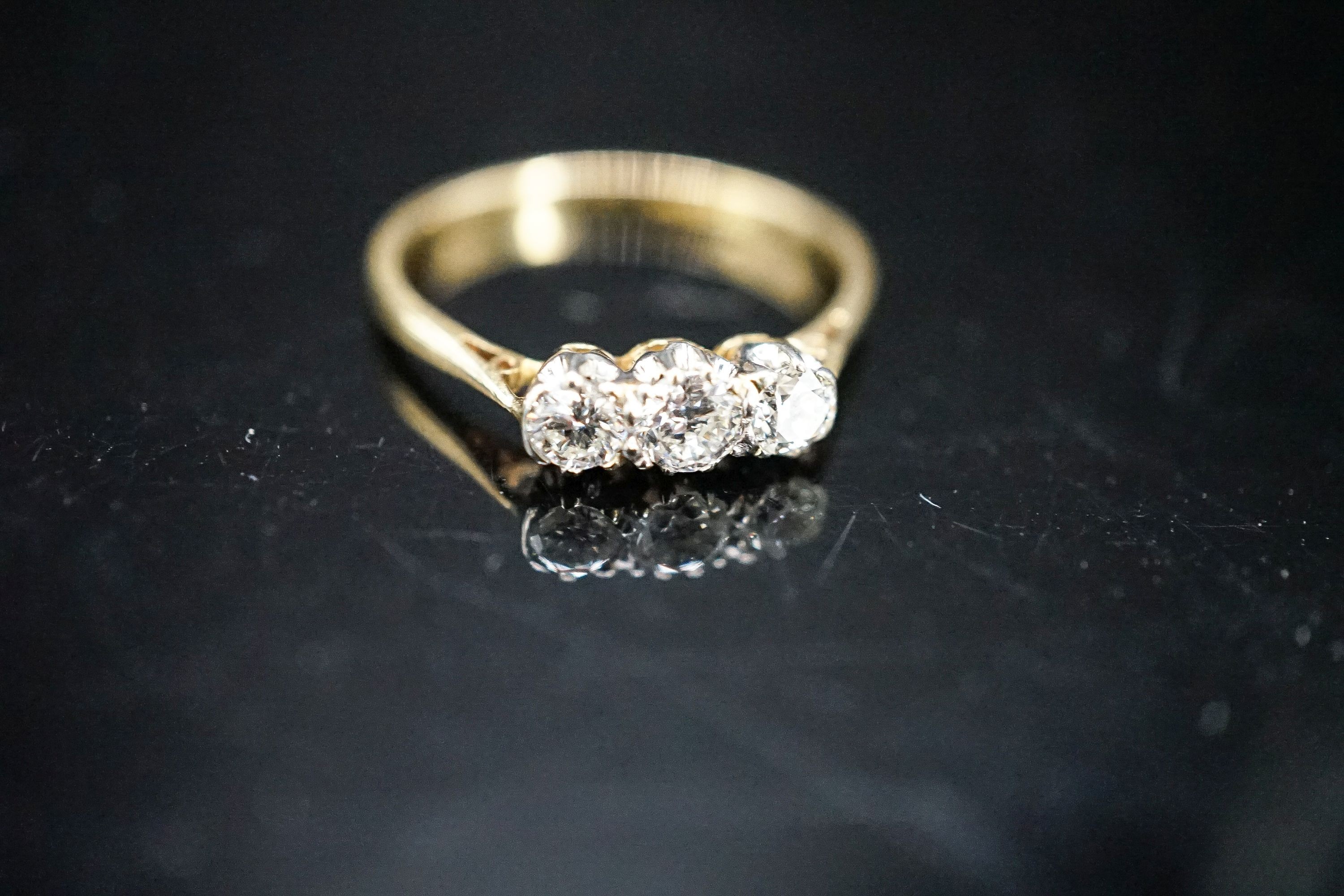 An 18ct & plat, three stone diamond ring, size O, gross 2 grams.